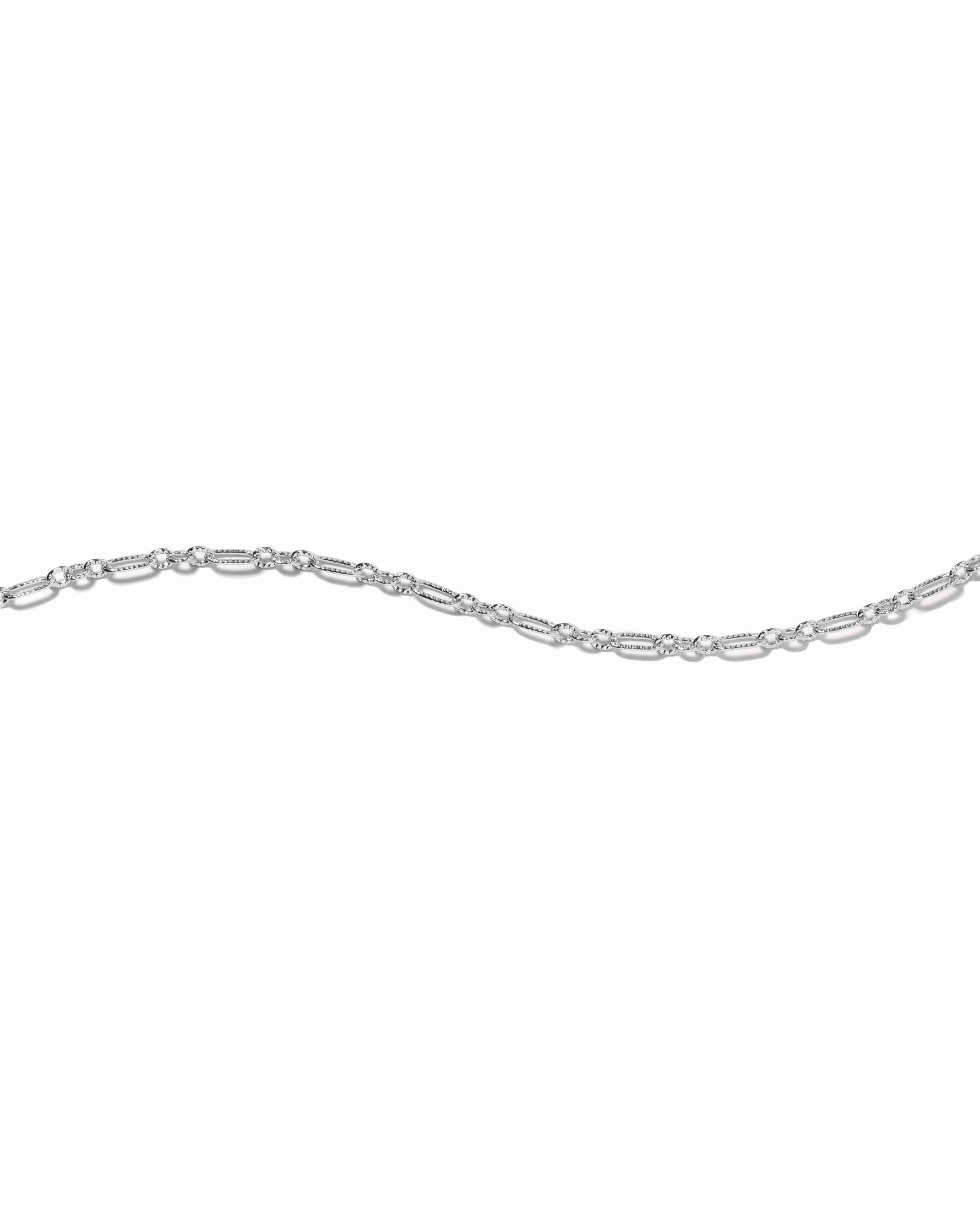 silver chain link stacking bracelet on white background