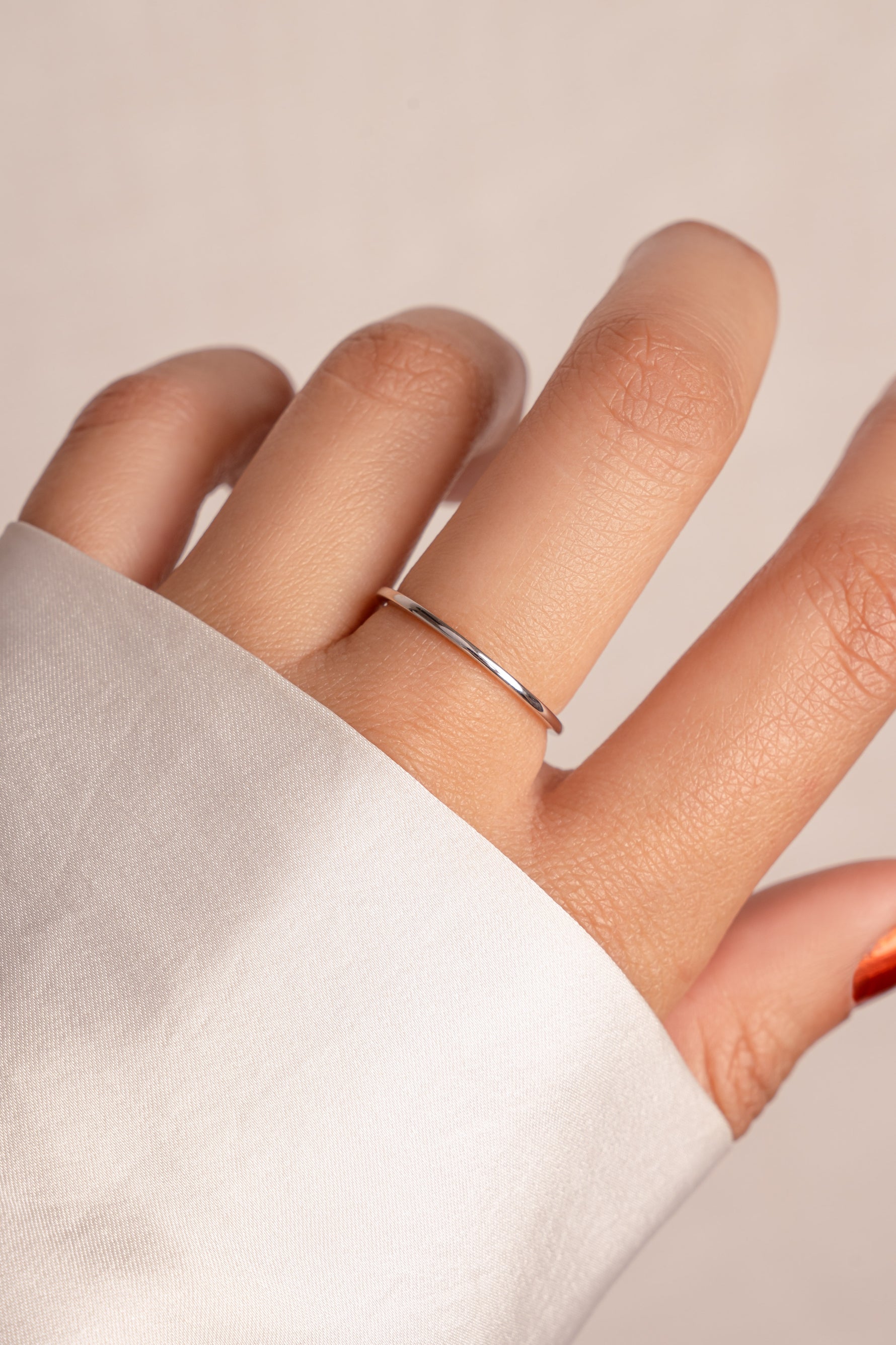 Delicate thin sterling silver stacking ring on model. 