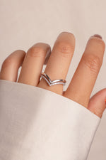 Model wearing trendy sterling silver chevron ring set with one pavé band and one plain band