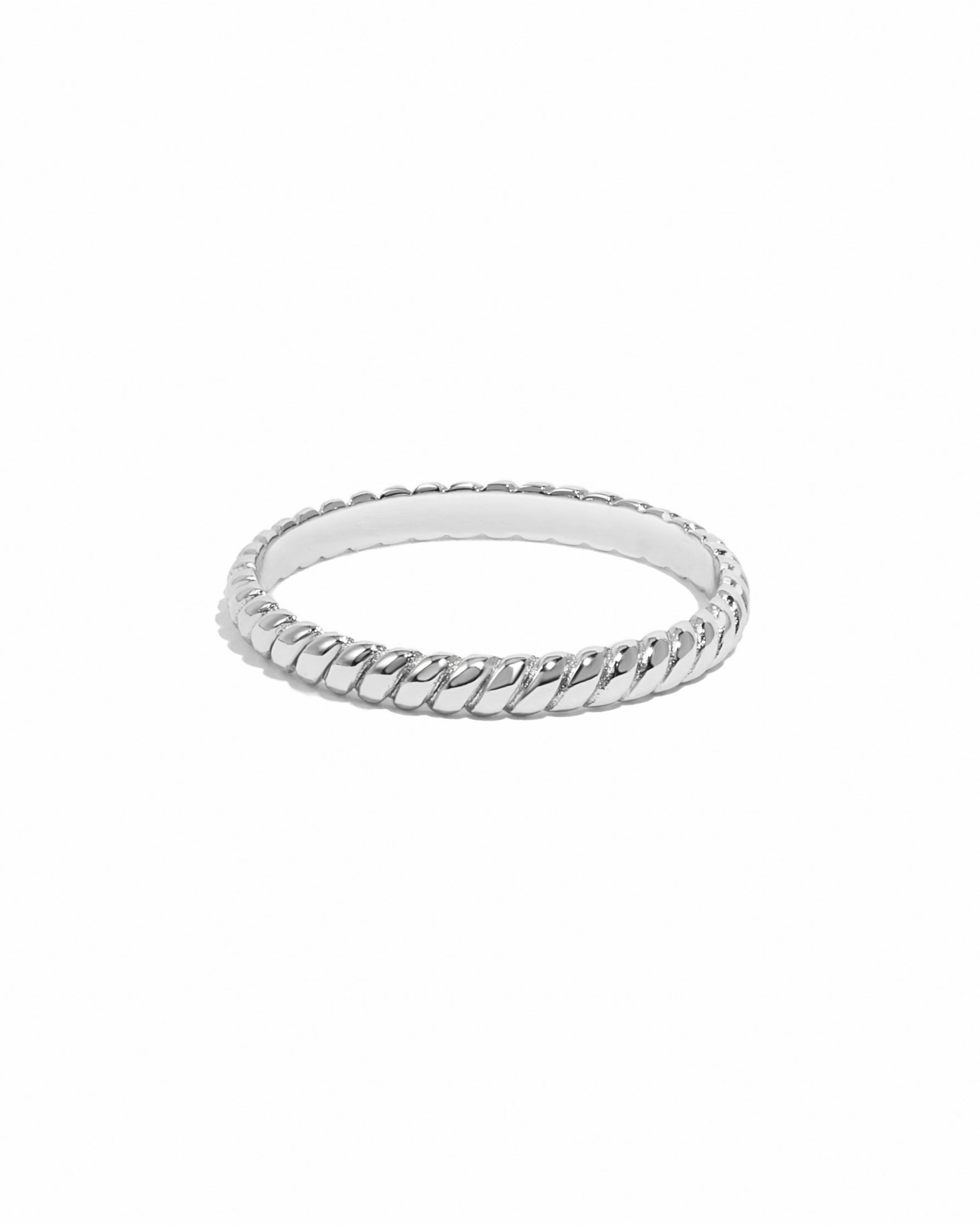 Silver ring with a textured band on a white background