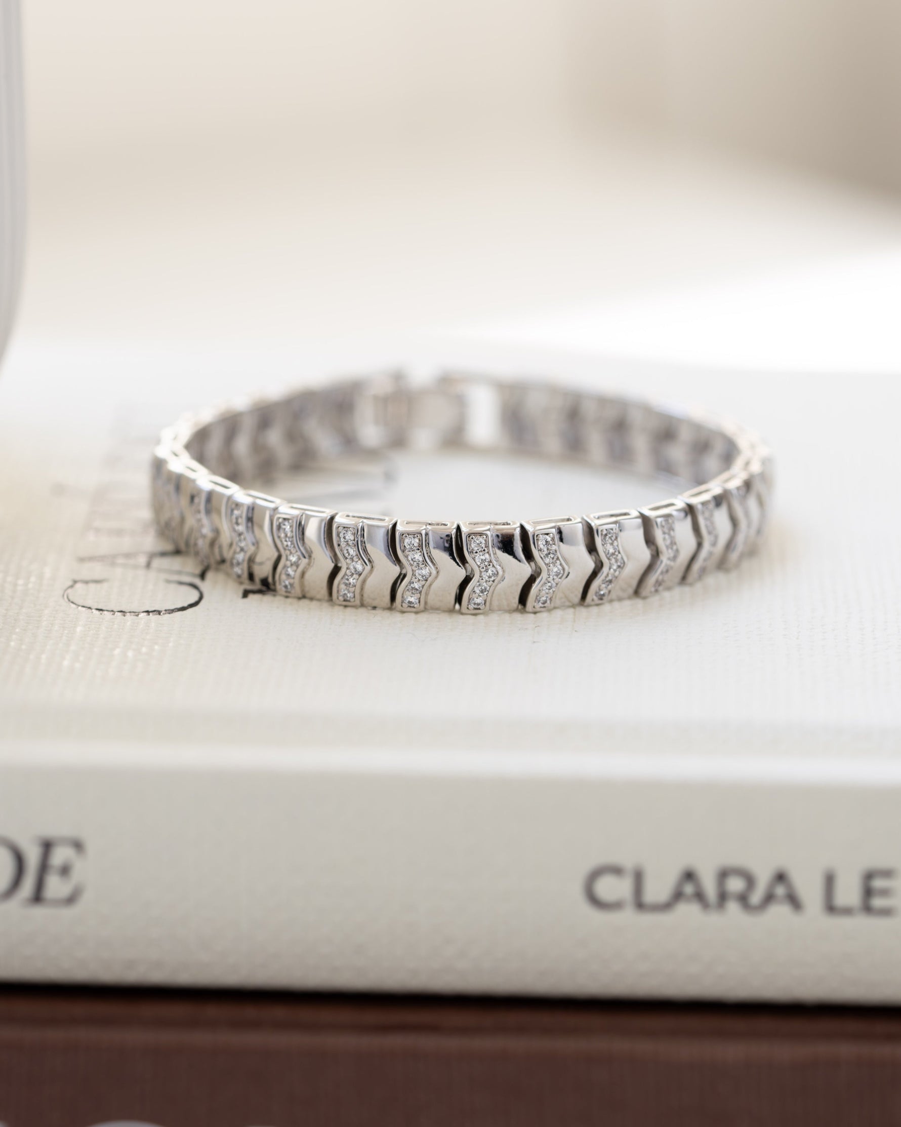 Silver chevron vintage bracelet on coffee table books