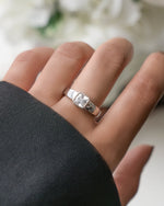 Closeup image of sterling silver square ring on models hand