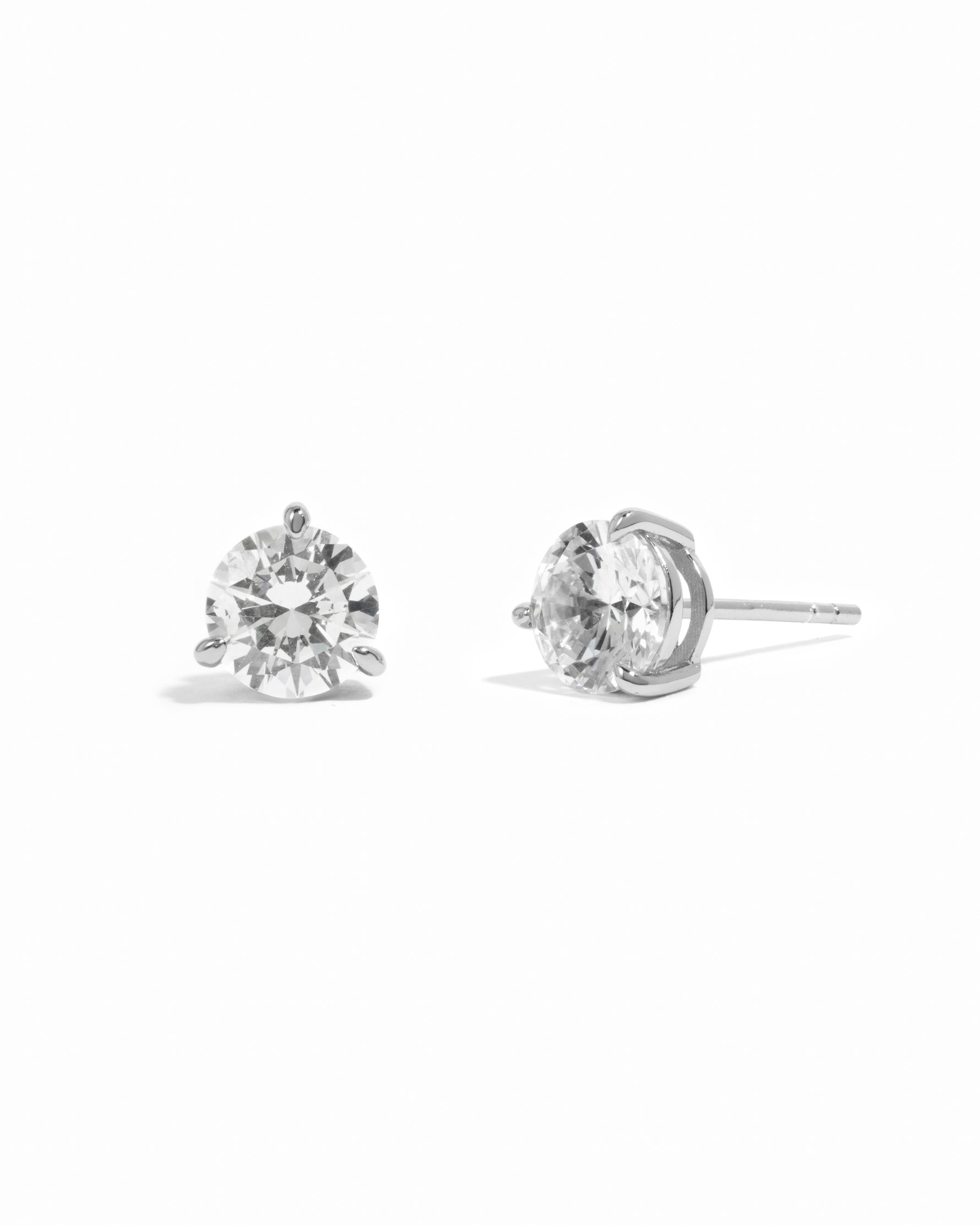 Silver diamond earrings on a white background