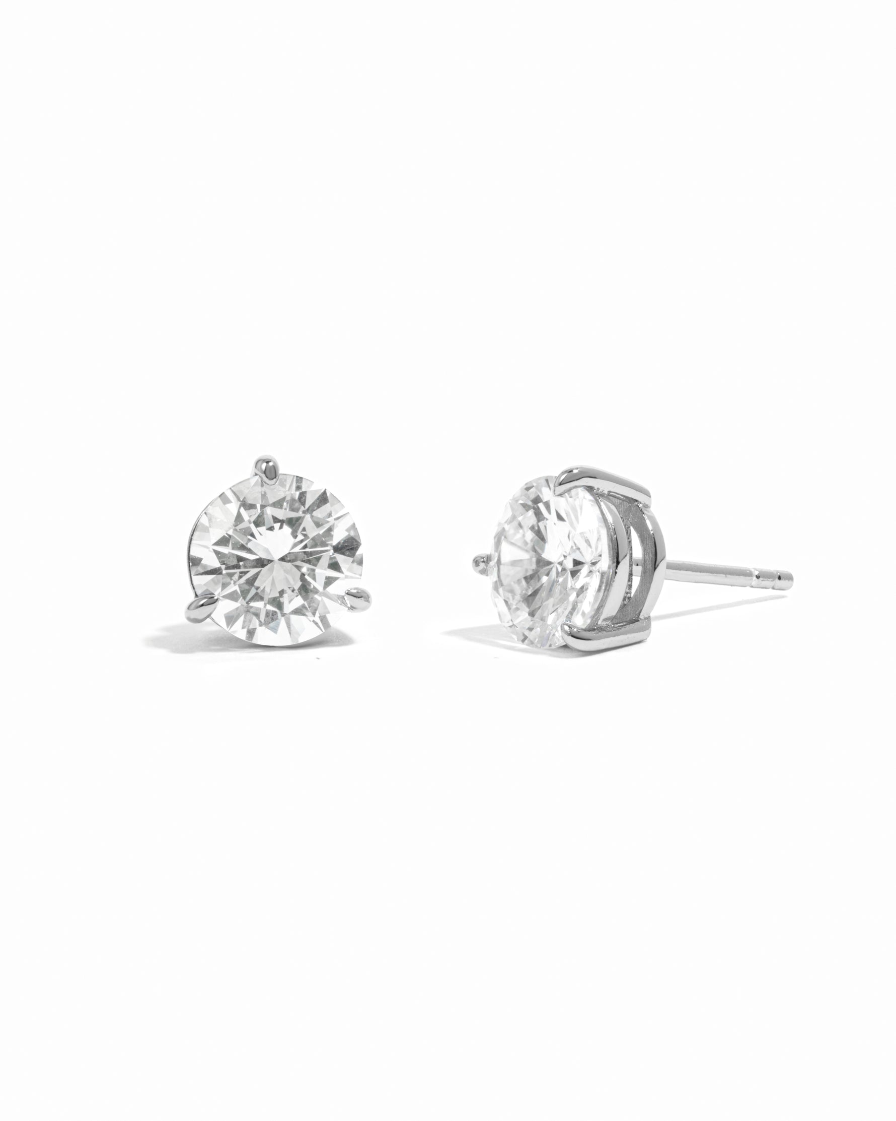 Silver diamond earrings on a white background