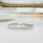 Closeup image of sterling silver tennis bracelet with baguette diamonds
