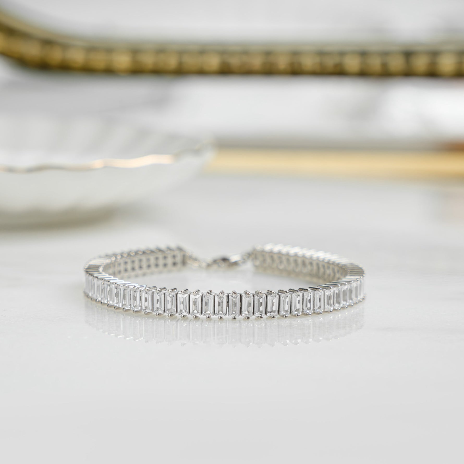 Closeup image of sterling silver tennis bracelet with baguette diamonds