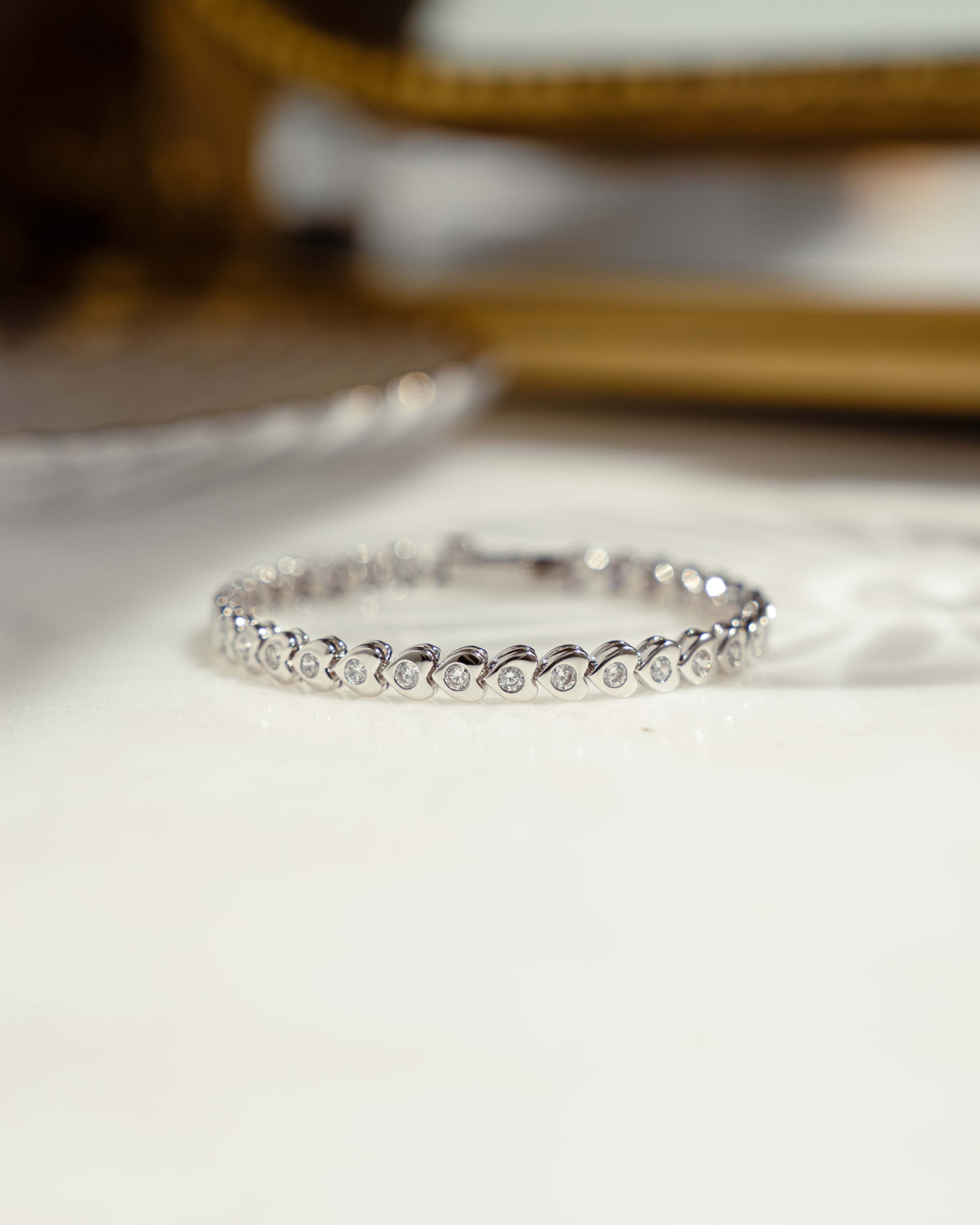 closeup image of silver heart tennis bracelet