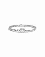 Silver tennis bracelet with a baguette diamond on a white background