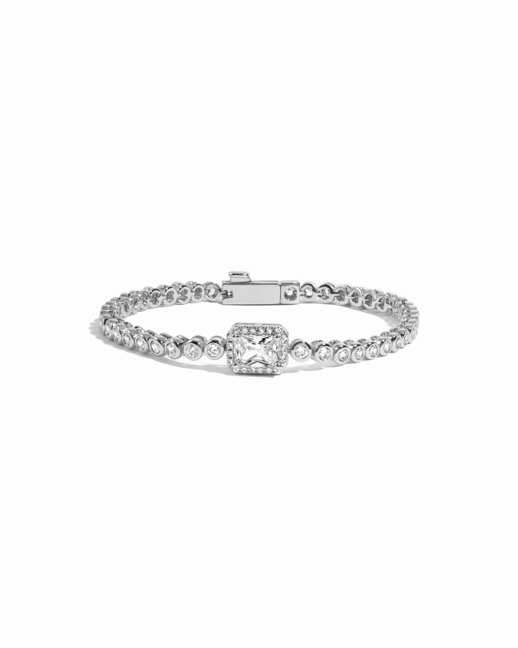 Silver tennis bracelet with a baguette diamond on a white background