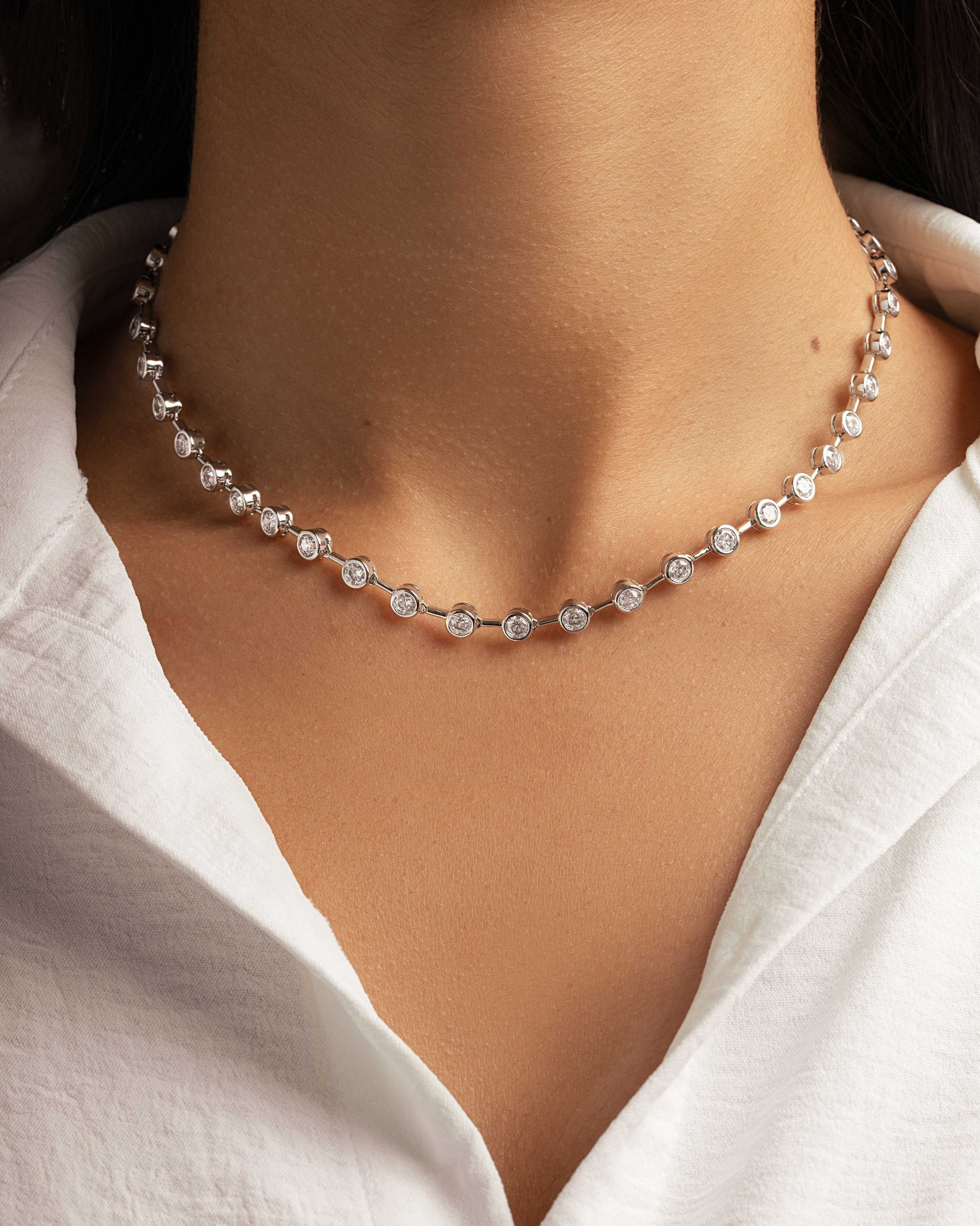 Silver wedding necklace with a tennis necklace design on model 