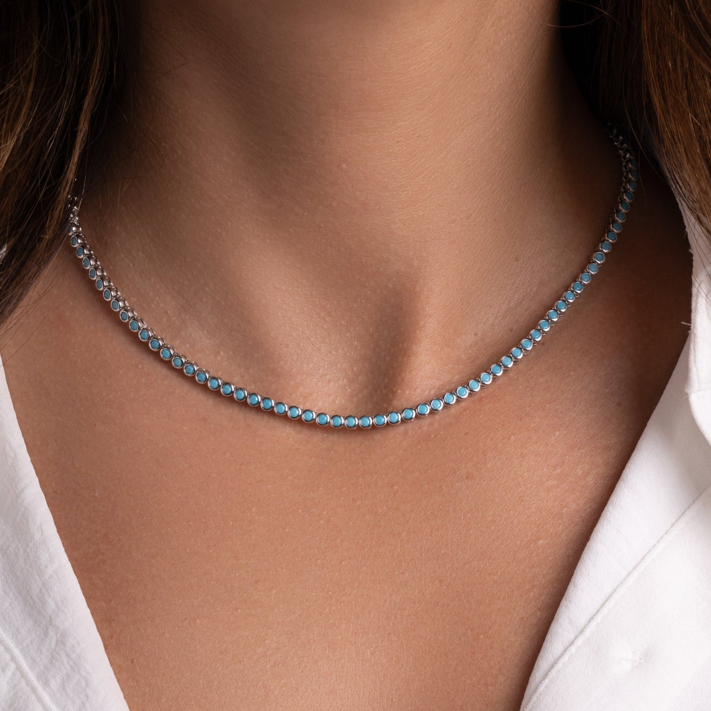 closeup image of turquoise layer necklace with tennis chain design