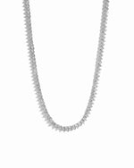Silver tennis necklace on a white background