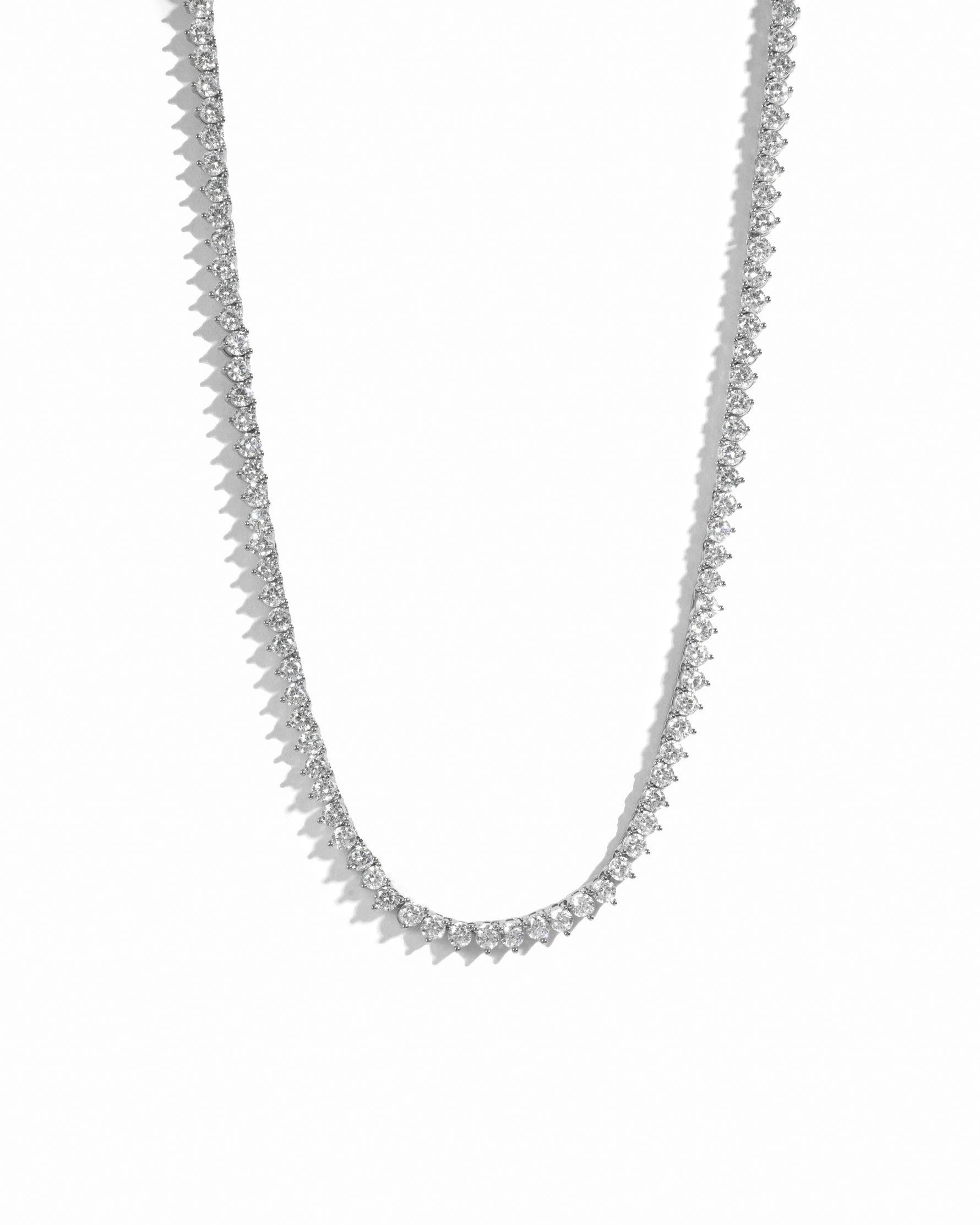 Silver tennis necklace on a white background