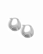 Silver thick hoop earrings on a white background