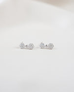 Pair of floral earrings with a drop earring design on a white background