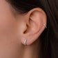 model wearing a silver small hoop earring featuring a minimalist diamond hoop design and a dainty silver cartilage hoop