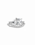 Silver Toi Et moi matching band set, featuring, a pear-cut and emerald cut stone on a plain silver band, with a matching pave curved silver band 