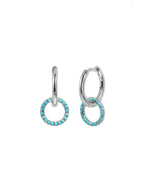 Silver hoop earrings with turquoise stones on a white background