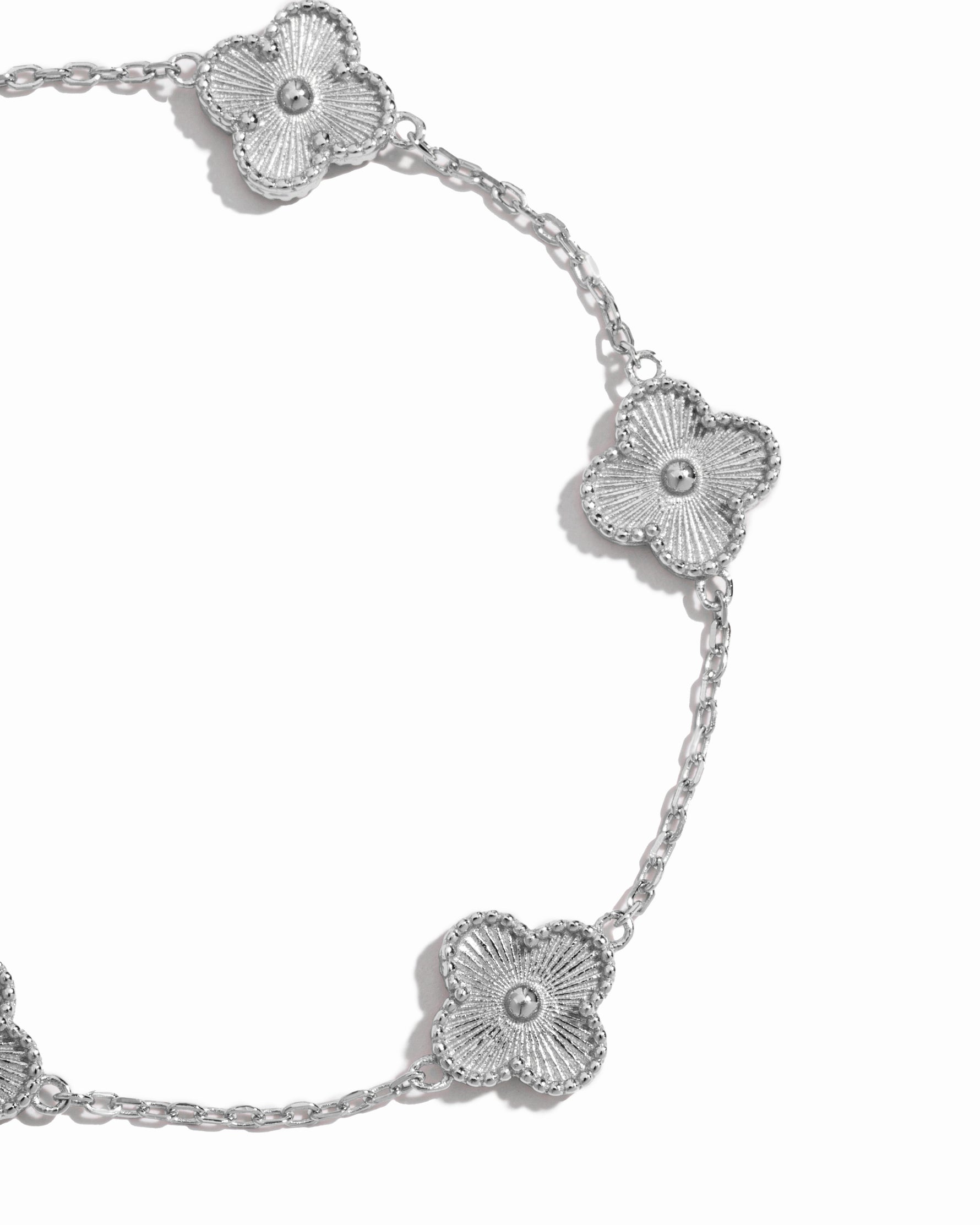 closeup image of intricate clover design on silver chain bracelet