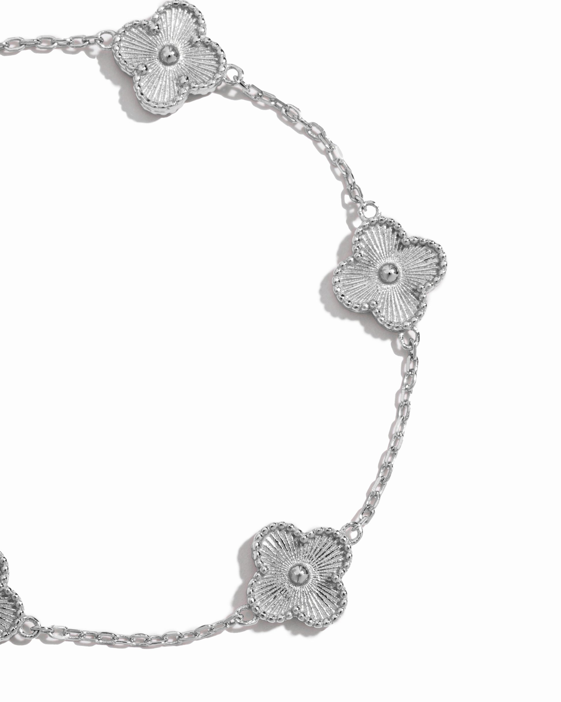 closeup image of intricate clover design on silver chain bracelet