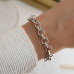 Model wearing silver bracelet with silver chain