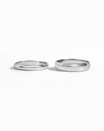two silver rings, one plain 3mm band and one 5mm stacking band