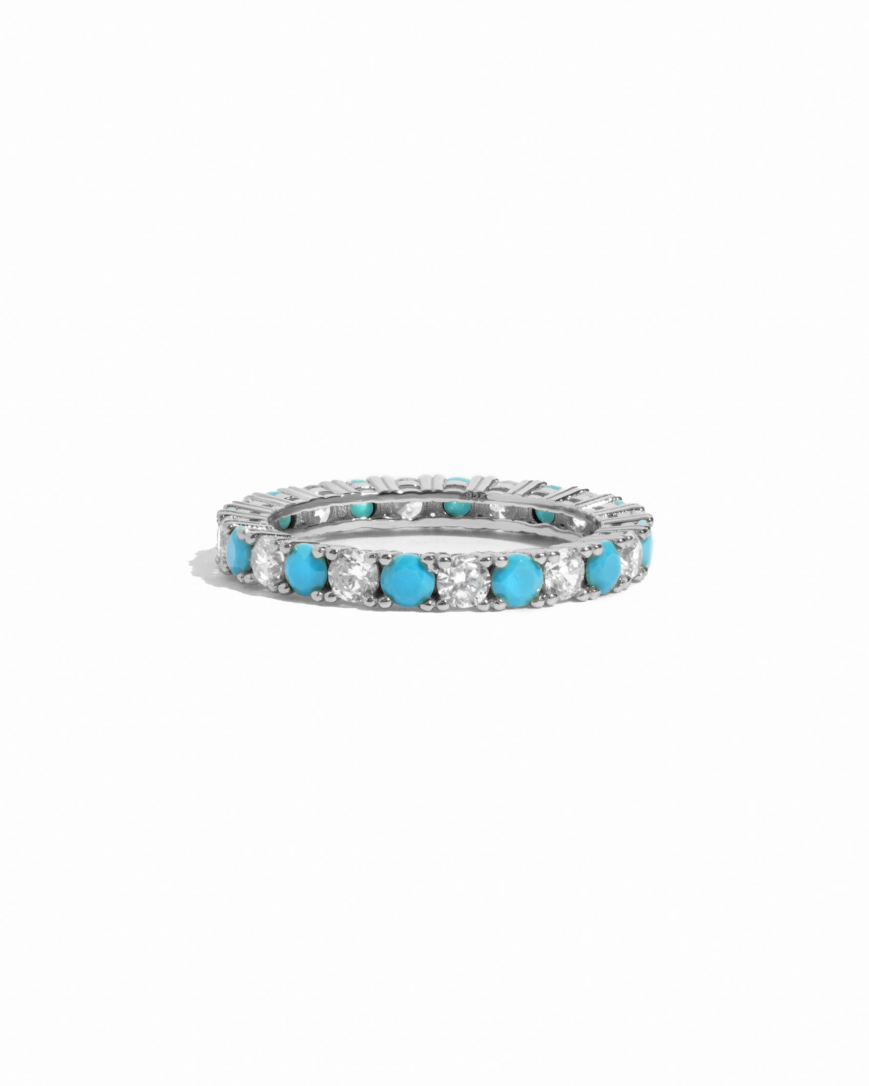 Eternity ring with turquoise and white cz stones on a white background