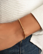 Gold beaded bracelet on model 