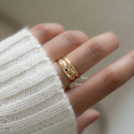 model wearing gold bands shown together to illustrate size differences or can be worn together.