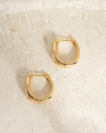Gold huggie starburst earrings