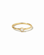 closeup image of gold solitaire stacking ring 