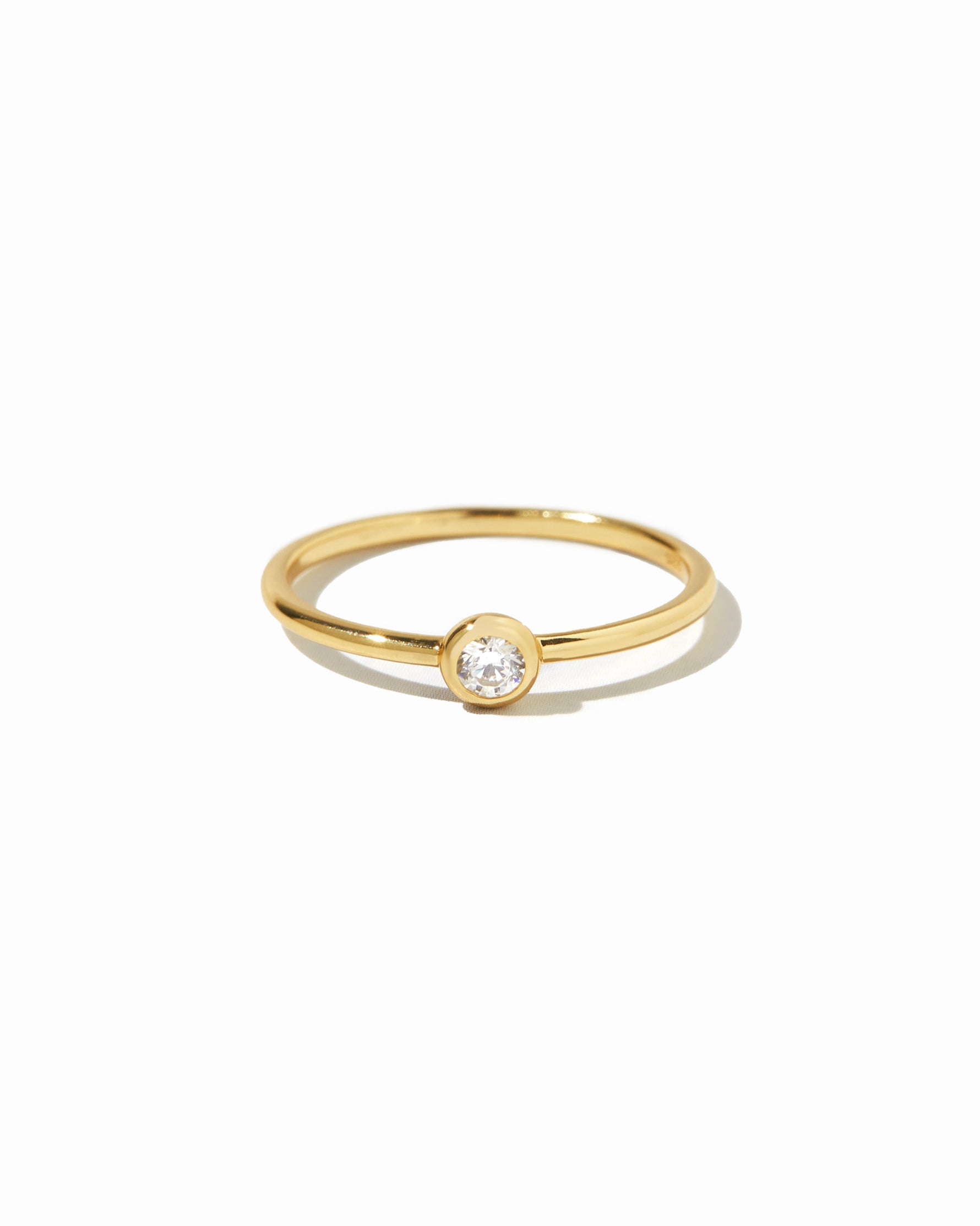 closeup image of gold solitaire stacking ring 