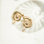 closeup image pf gold statement earrings