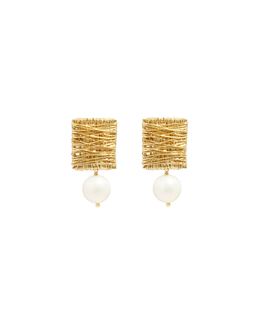 closeup image of gold pearl drop earrings