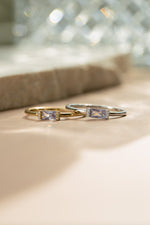 Gold and sterling silver birthstone jewelry featuring baguette cut june birthstone stackable rings 