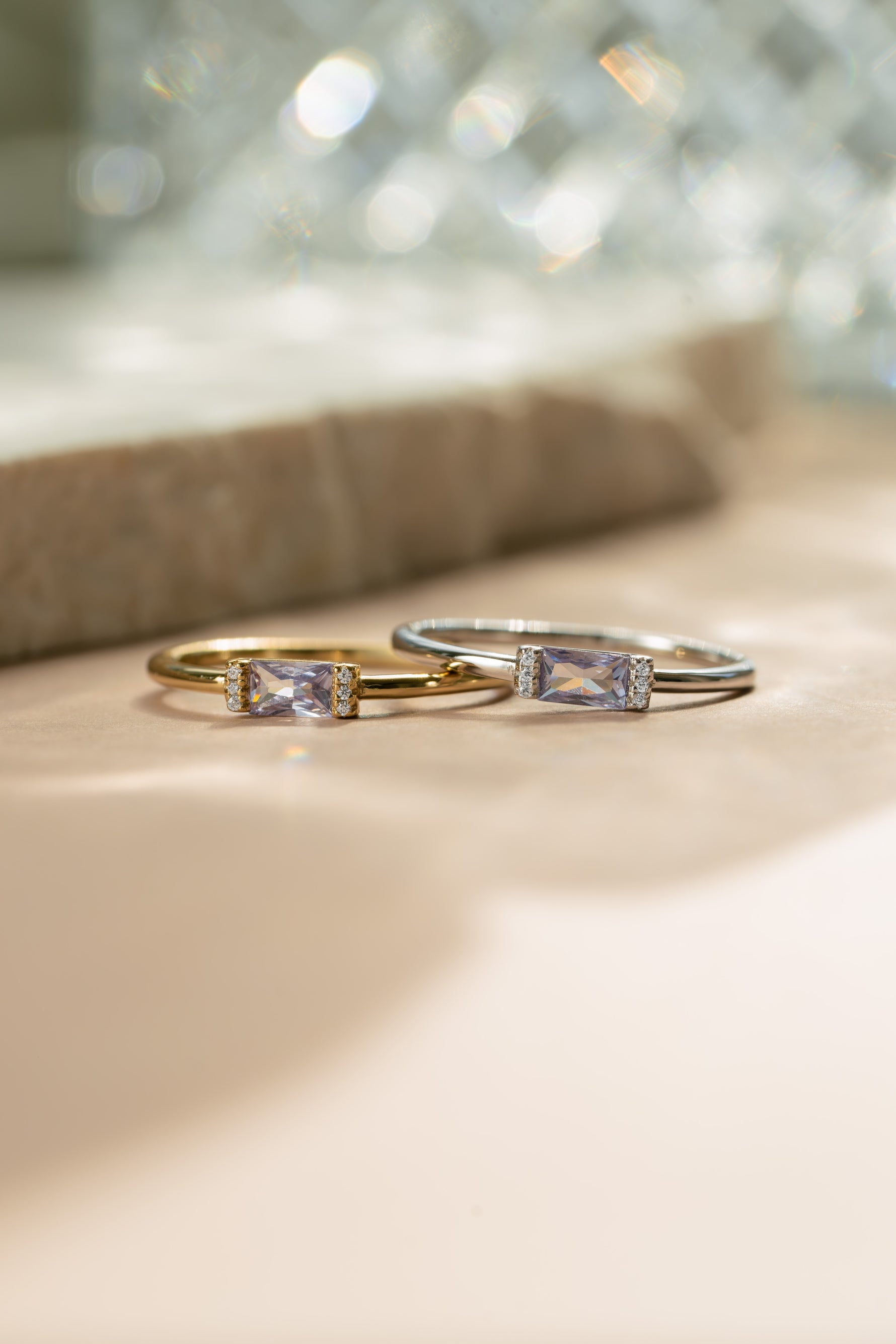 Gold and sterling silver birthstone jewelry featuring baguette cut june birthstone stackable rings 