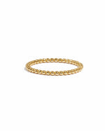 Gold beaded ring on a white background
