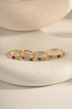 closeup image of closeup birthstone rings ranging from 2 stone, 3 stone, 4 stone and 5 stone