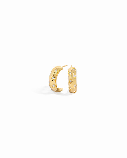 Closeup of celestial earrings with delicate details