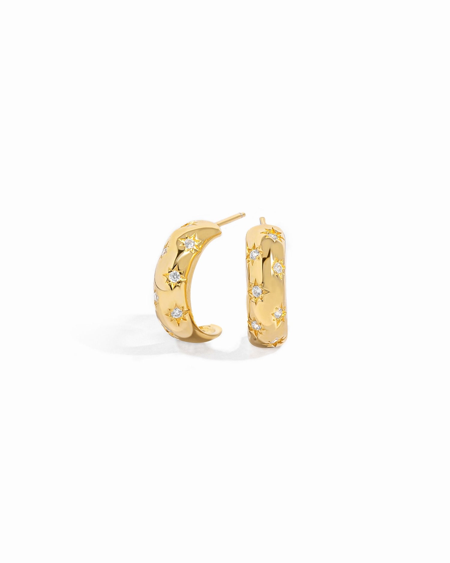 Closeup of celestial earrings with delicate details
