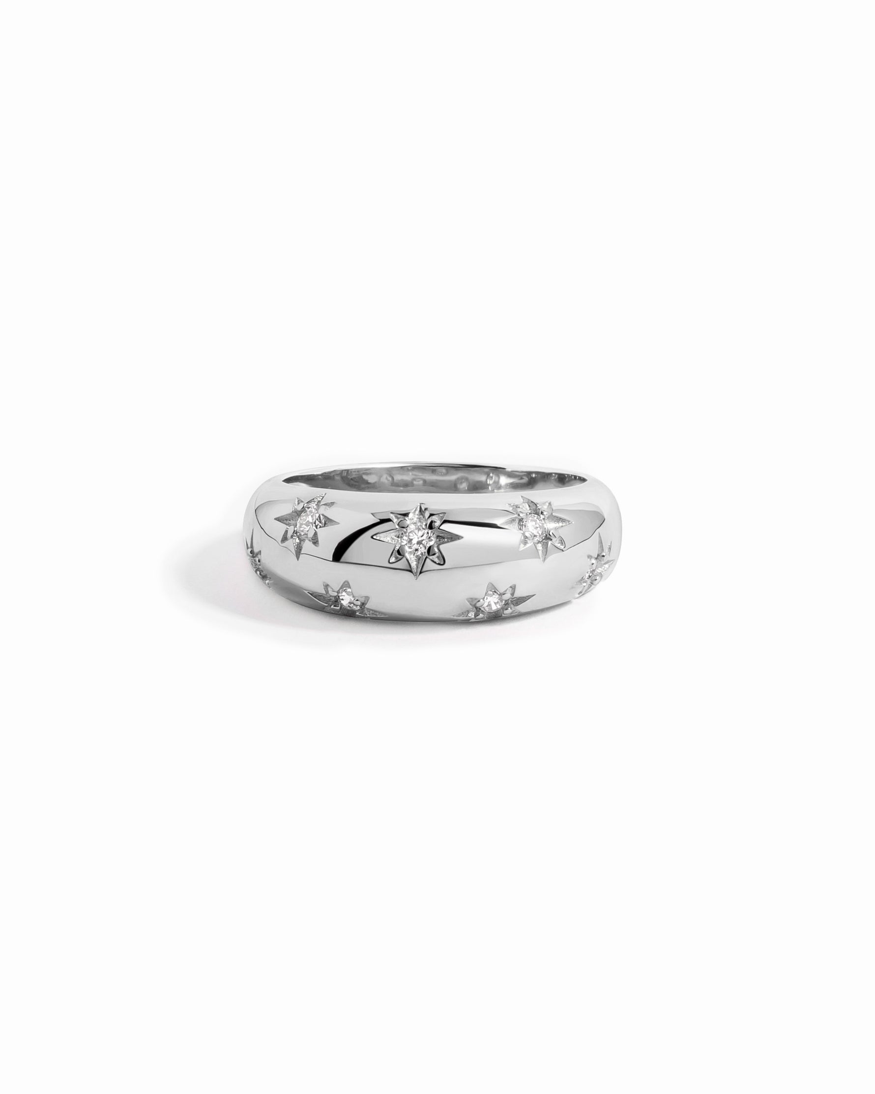 Silver statement ring with star-shaped cutout design on a white background