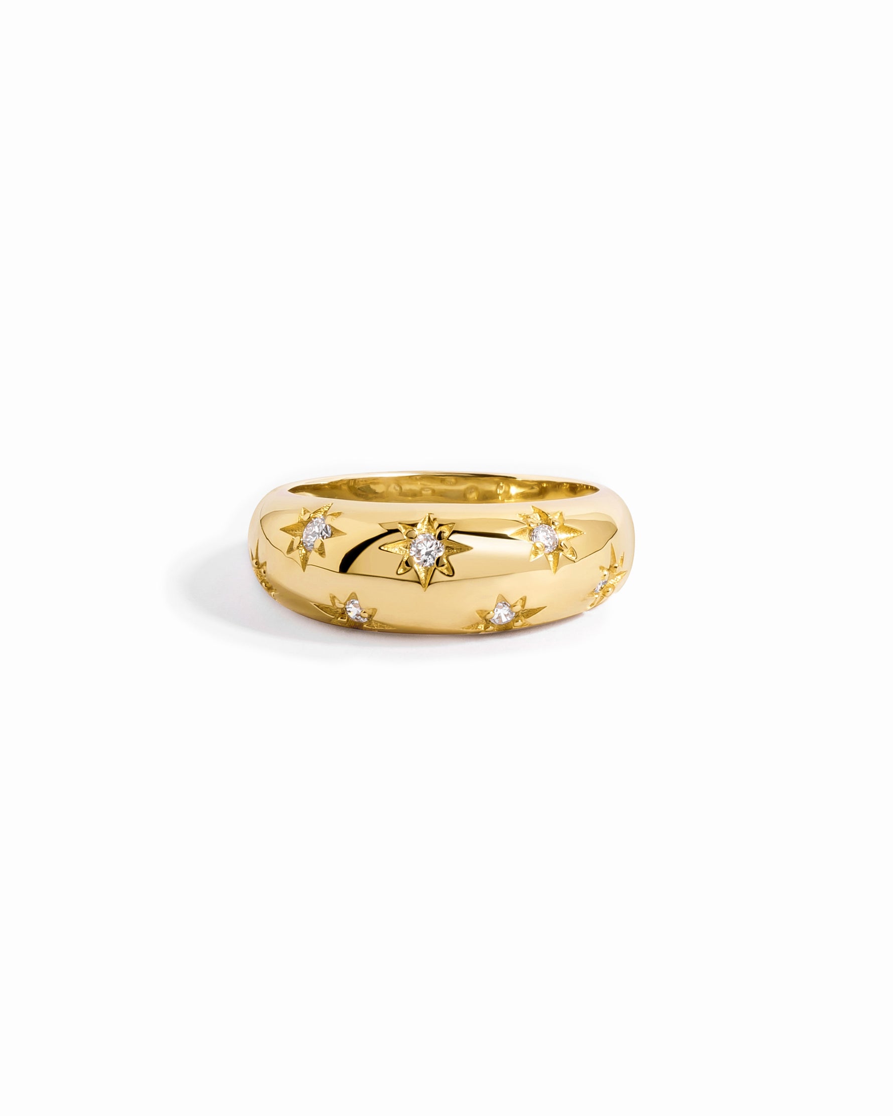 Closeup image of a gold dome ring with cubic zirconia stars