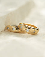 Celestial jewelry featuring small gold hoops 