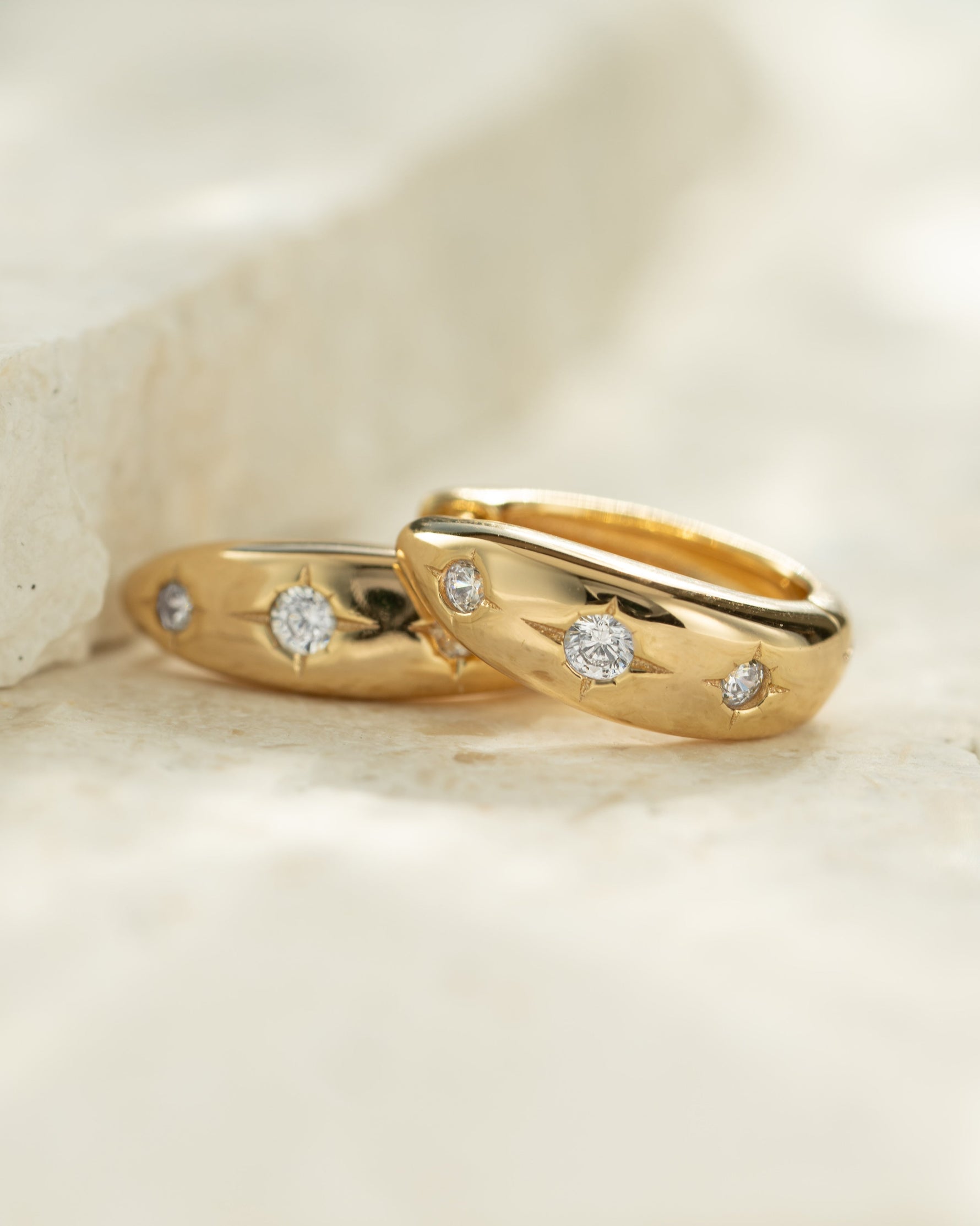 Celestial jewelry featuring small gold hoops 