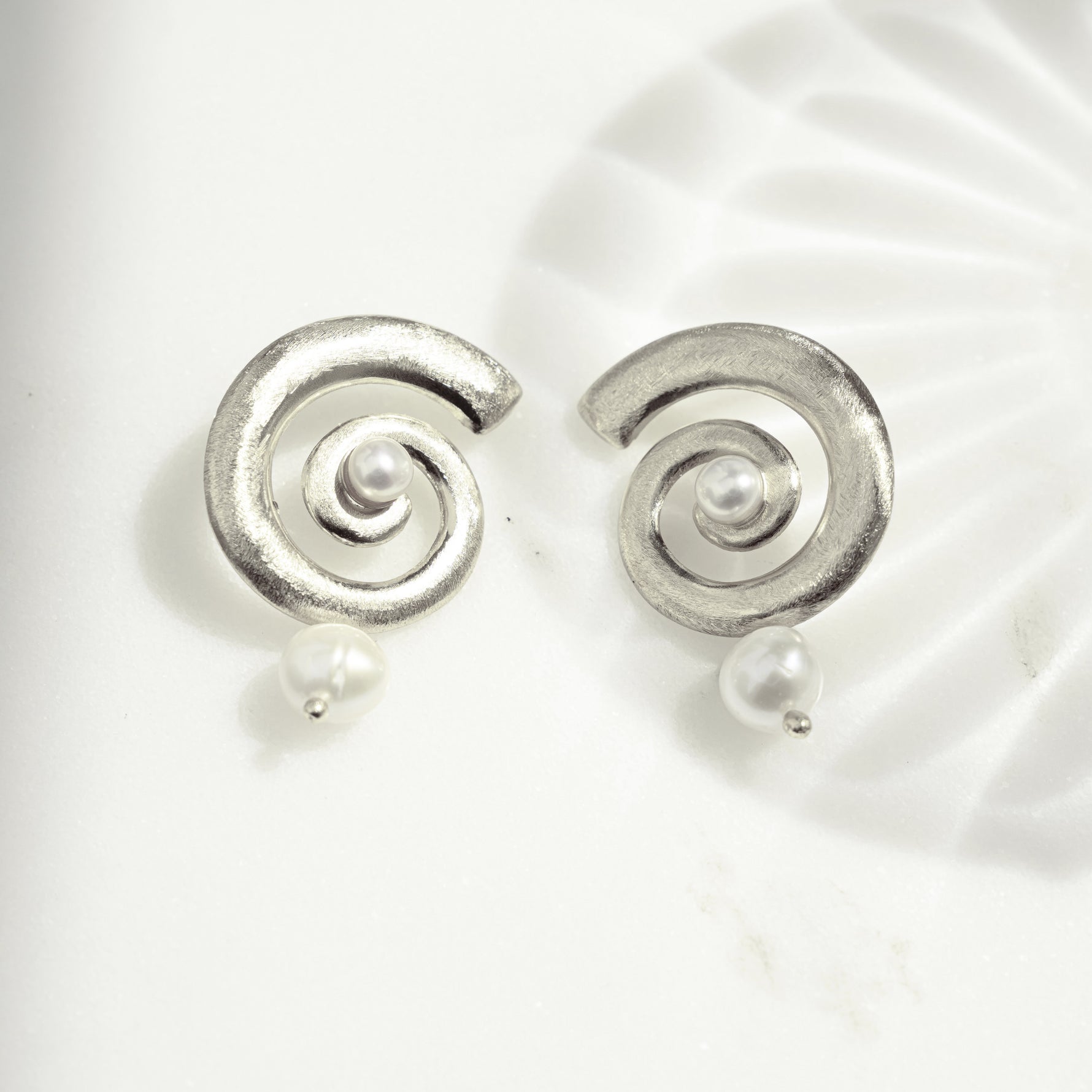silver shell earrings with a dangle drop earring design