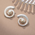 closeup image of pearl earrings featuring a boho earring spiral earring design