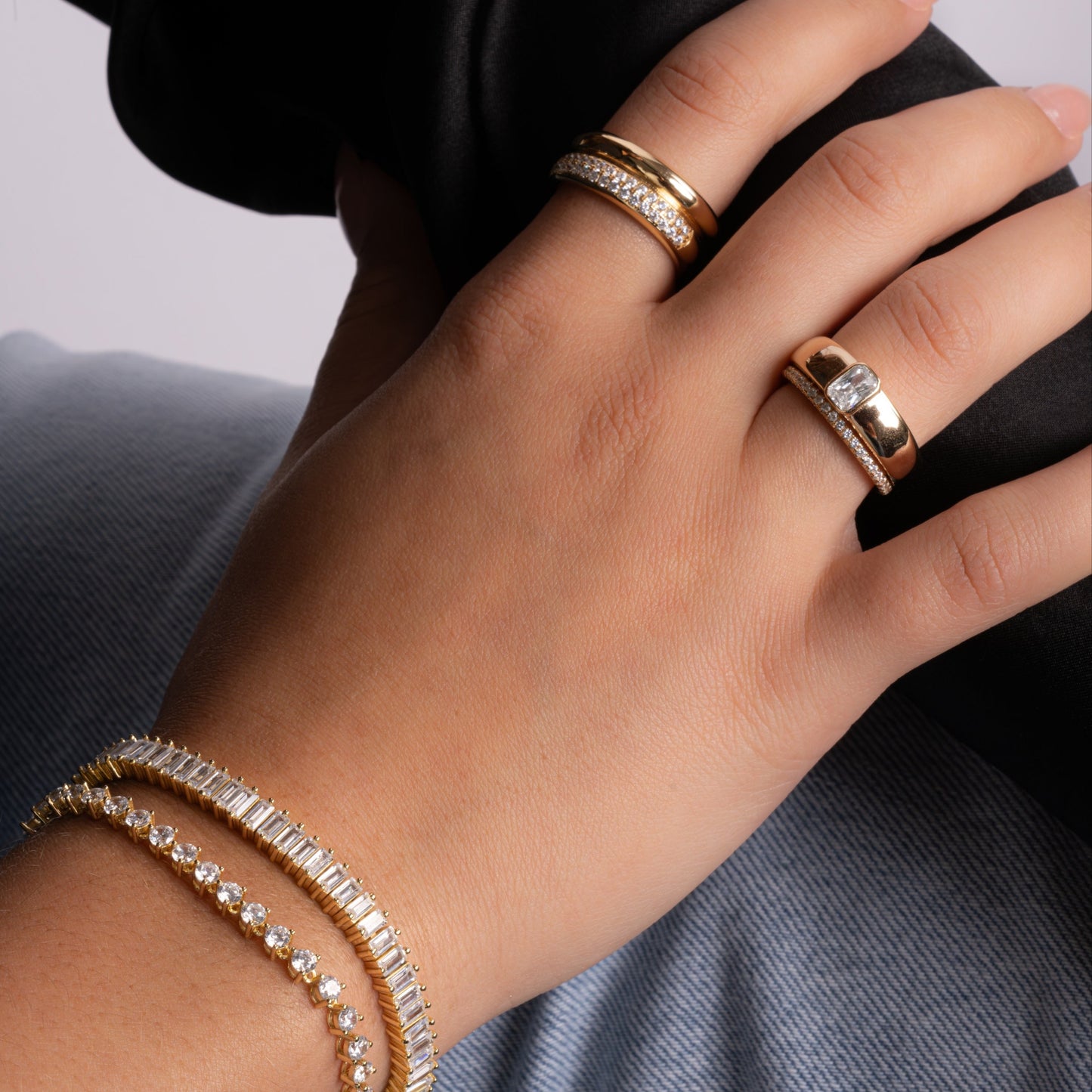 model wearing gold jewelry featuring unique statement ring