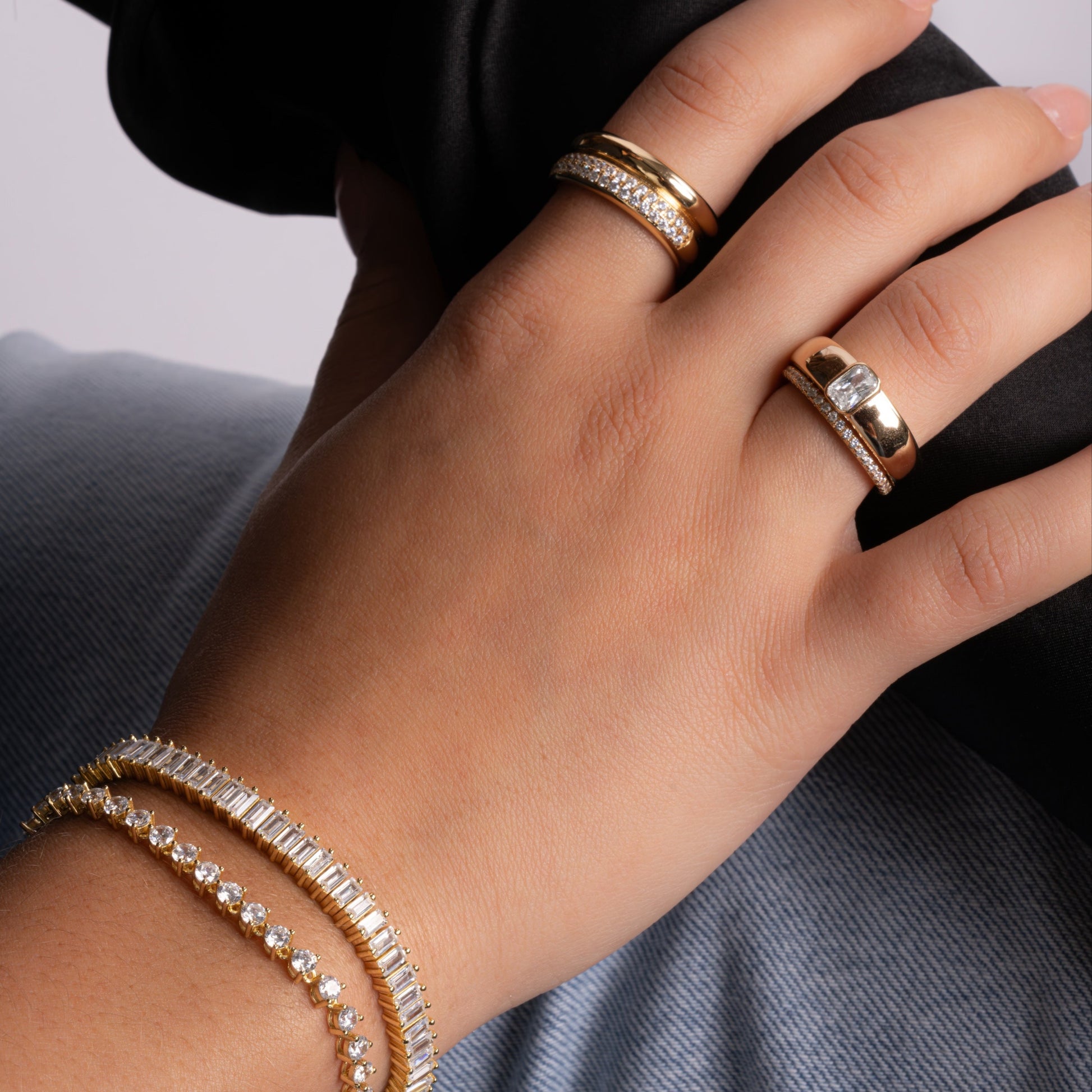model wearing gold jewelry featuring unique statement ring