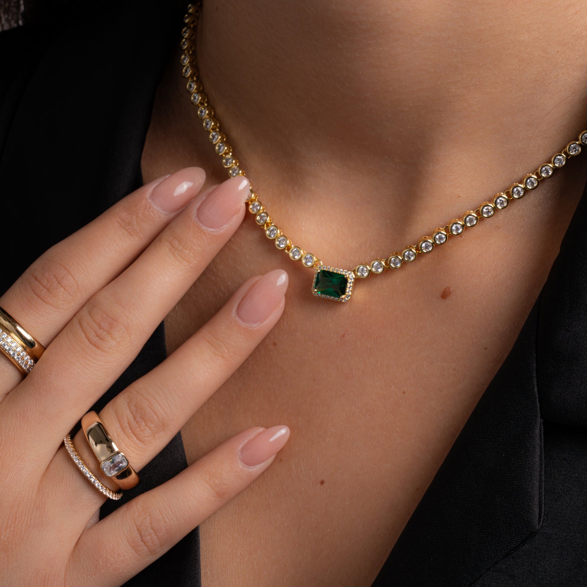 model wearing gold statement jewelry featuring baguette dome ring