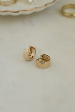 Gold hoop earrings with a thick statement earring design 